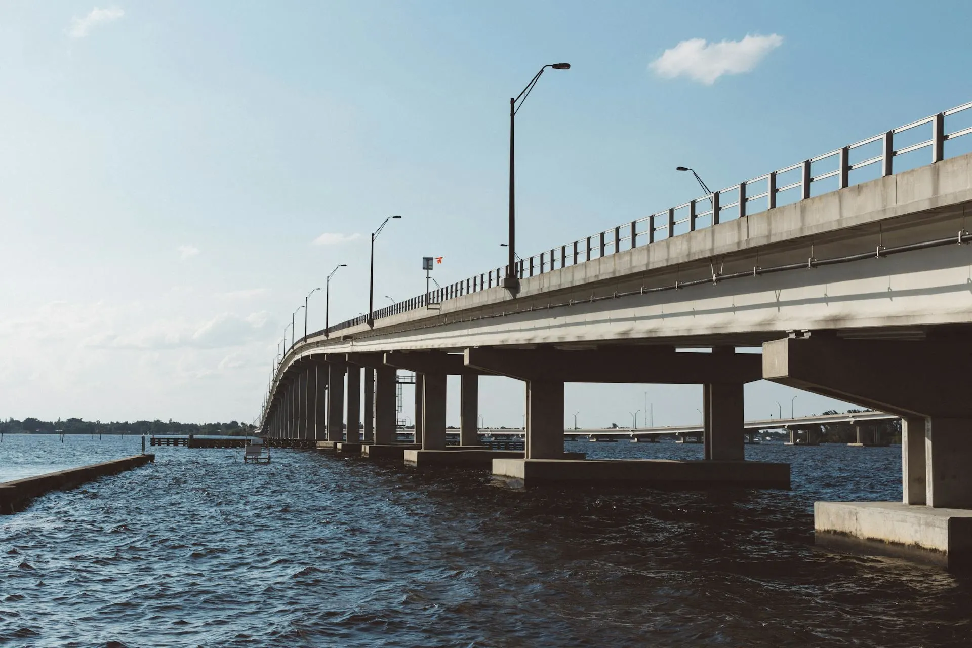 Modern concrete bridge over water showcasing major infrastructure project in global construction industry September 2024